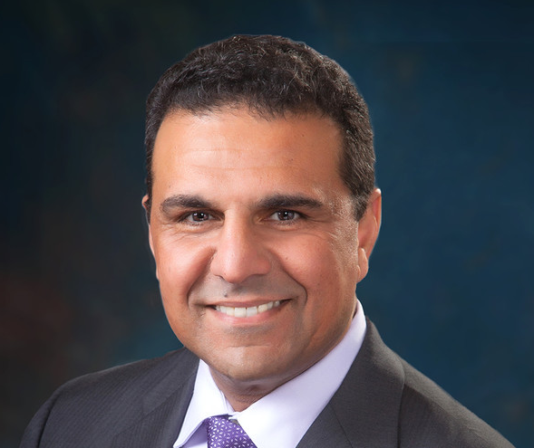 cropped headshot of San Guedouar, Roland Park Place's President and CEO