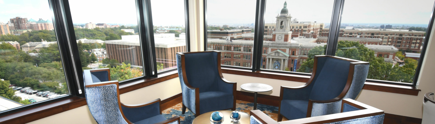 group of chairs gathered near expansive windows at Roland Park Place senior living