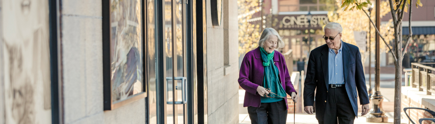 long narrow horizontal photo of a senior couple walking through downtown Baltimore