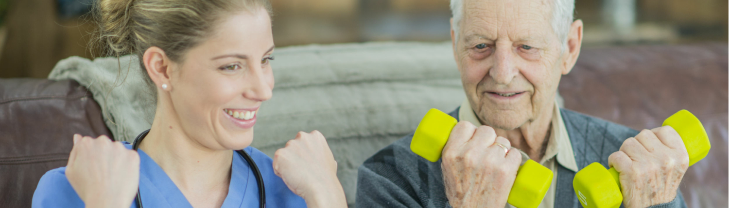 happy senior lifting light hand weights with nurse next to him