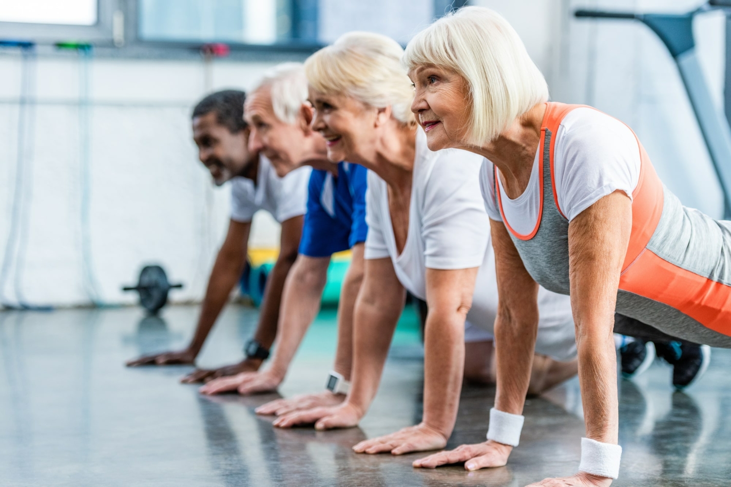 Image of a group of seniors doing push-ups in an exercise class.