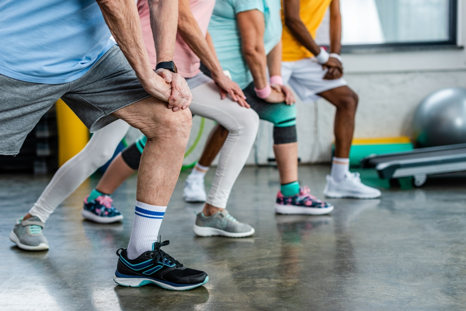 Image of a group of seniors stretching in a fitness class.