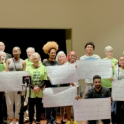 group photo of those involved in Roland Park Place’s scholarship program holding oversized checks